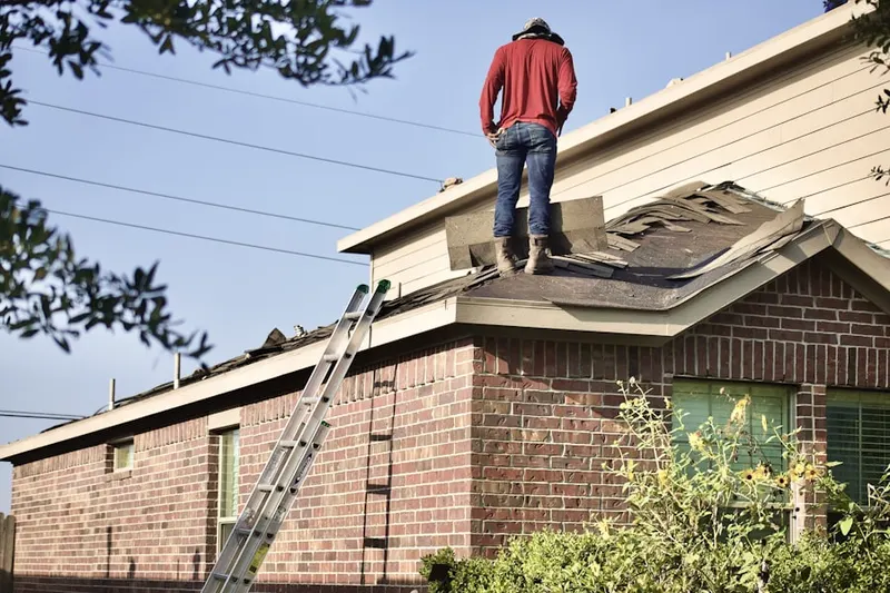 Professional roofer working on a residential roof in Camden Wyoming